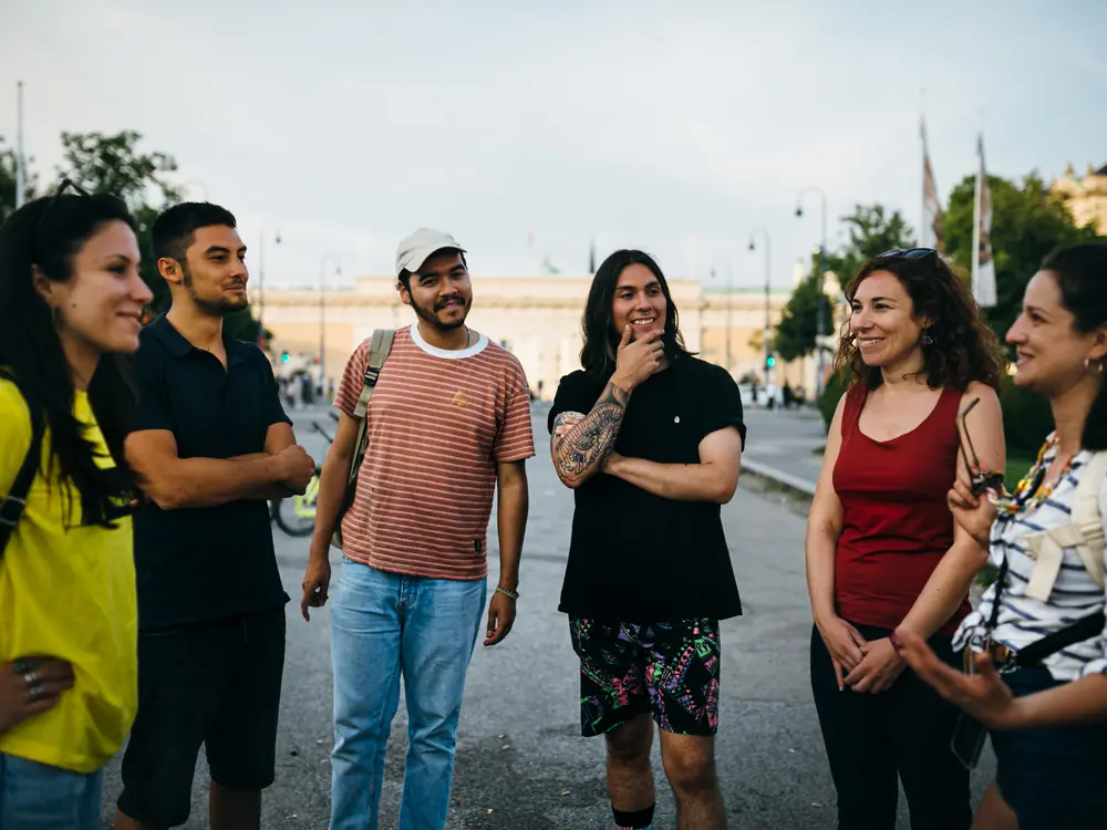 Smiling guests with their Prime Tours guide on a Vienna street