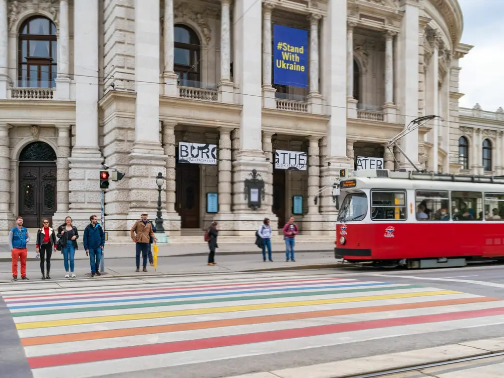 Red tram passing the Burgtheater on Vienna's Ringstrasse